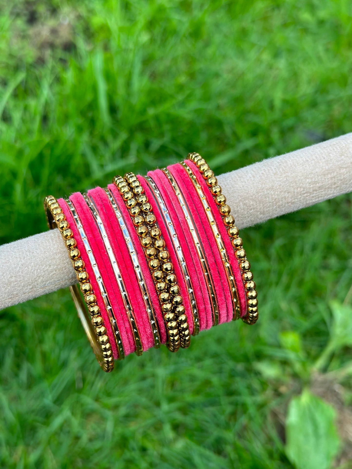 Carrot pink velvet bangles set with golden beaded kangan’s