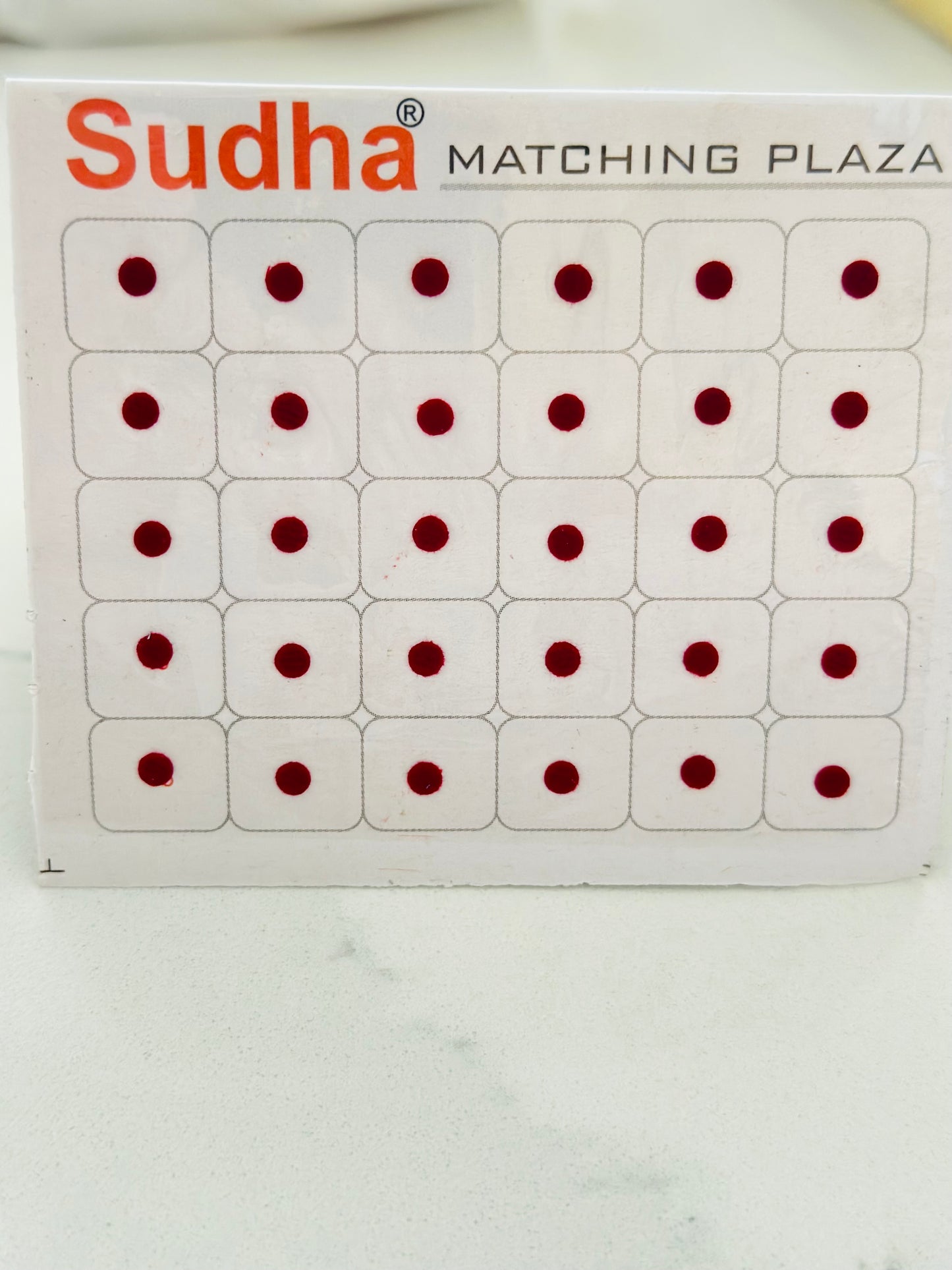 Round shape small bindi card in Maroon colour