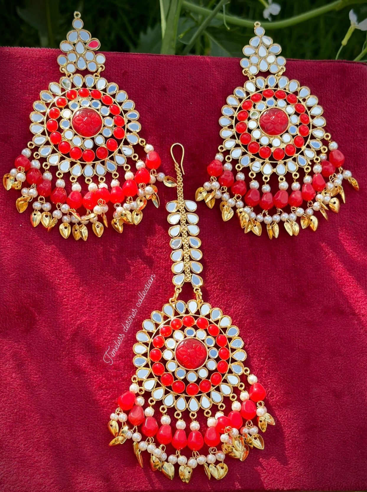 Red earrings and tikka set in mirror with pipal patti