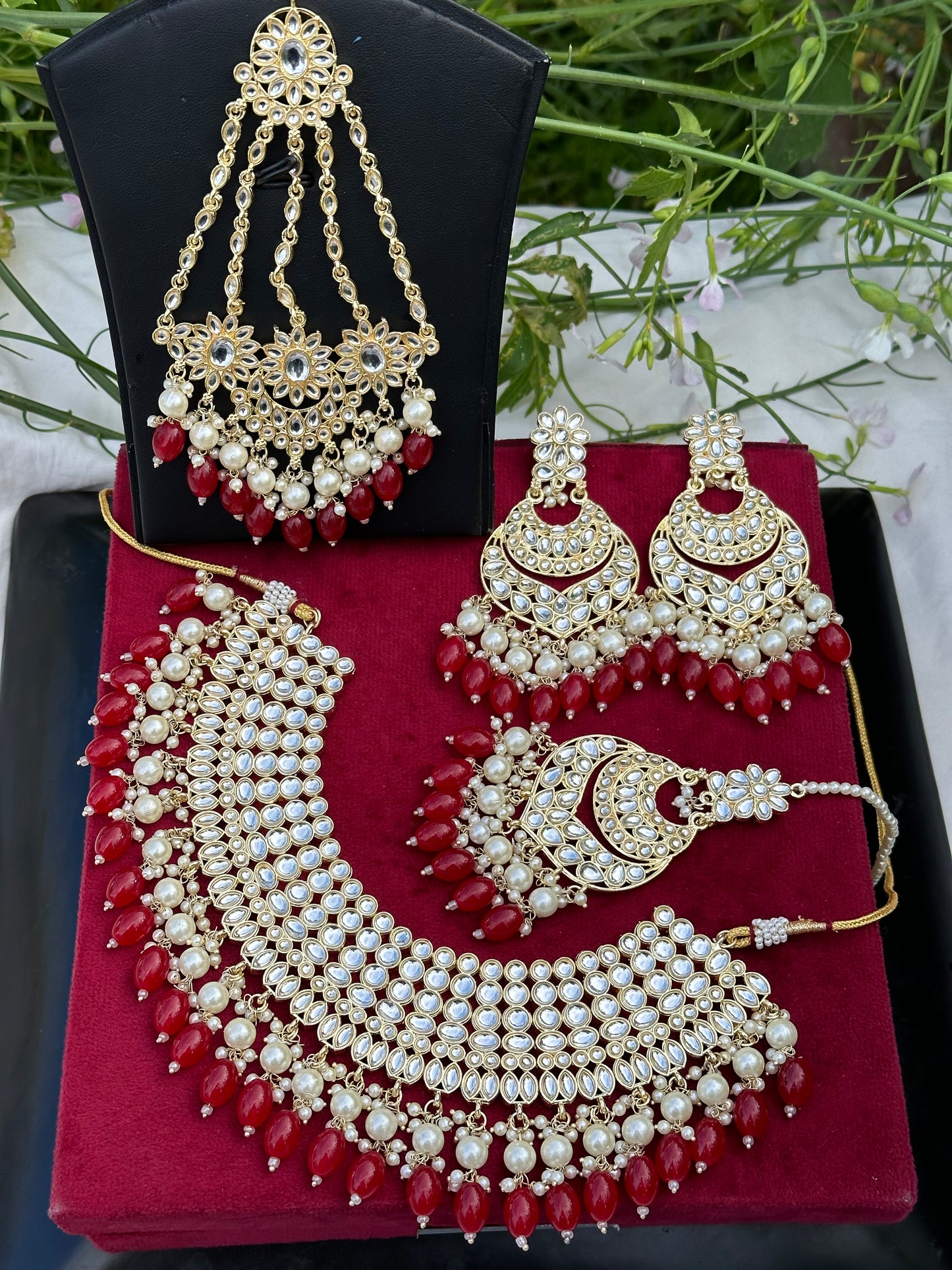 Pearl loaded necklace set with passa in Kundan in red colour