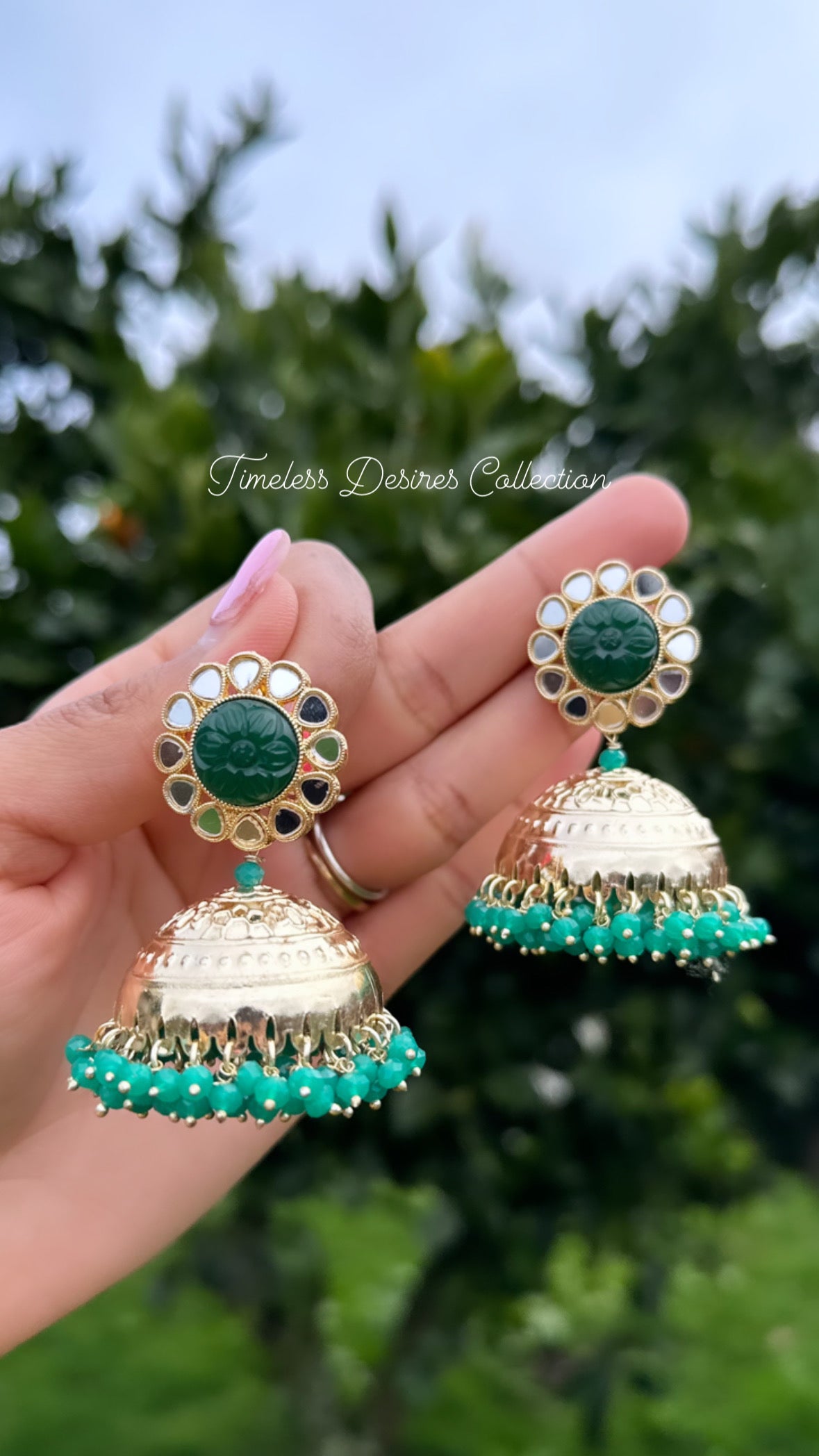 Green Jhumka Earrings in mirror