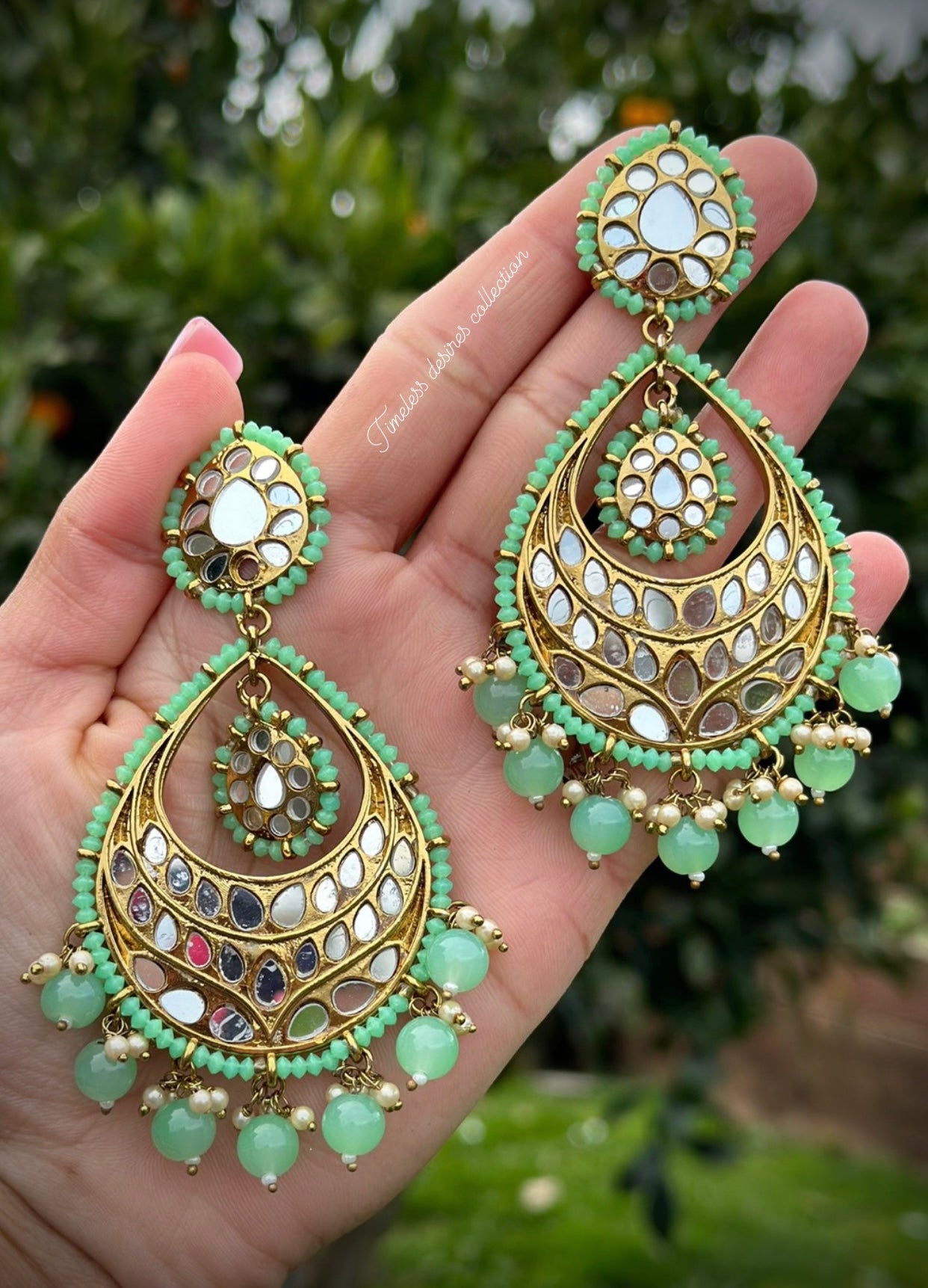 Mint green earrings in mirror