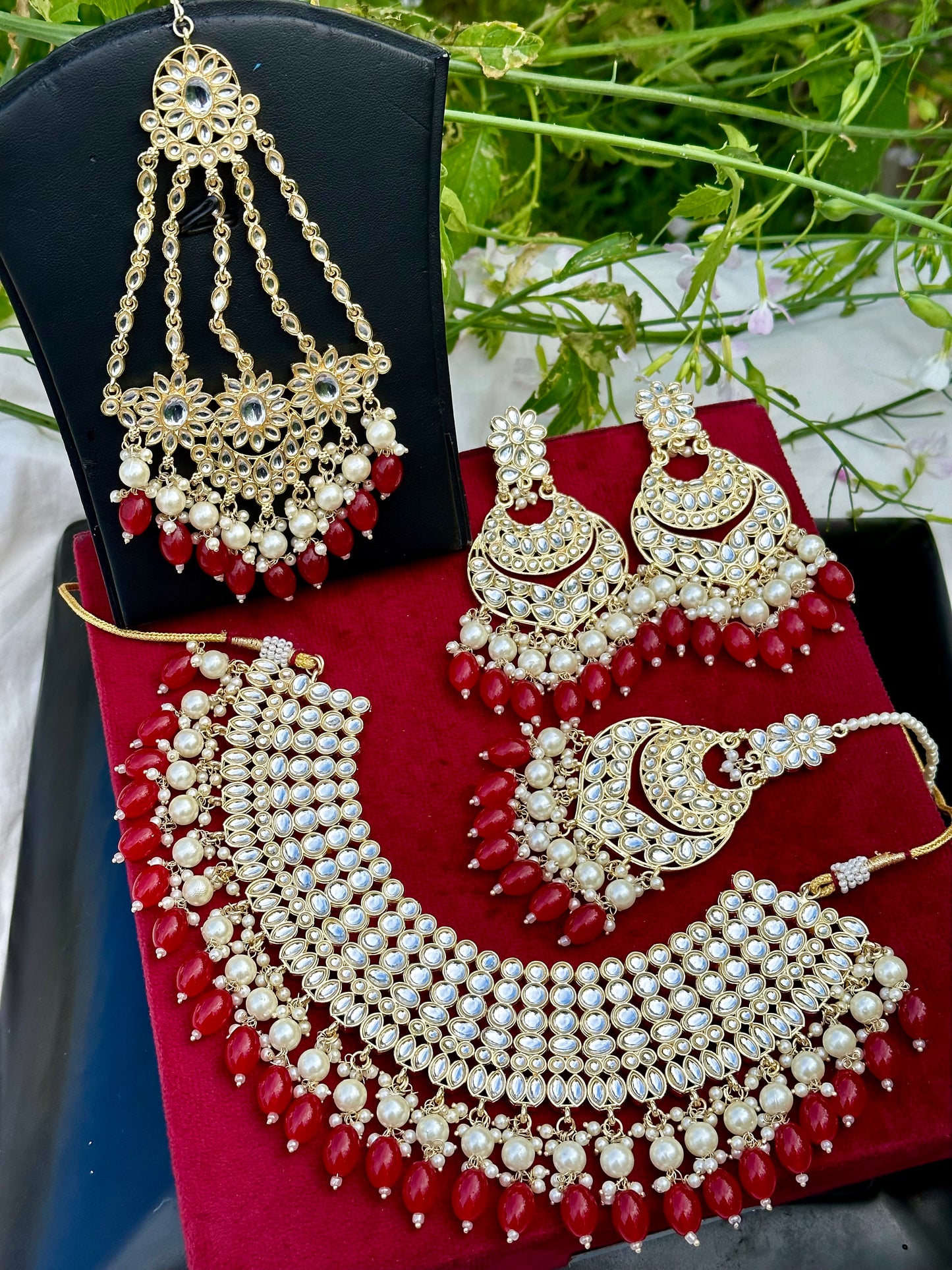 Pearl loaded necklace set with passa in Kundan in red colour