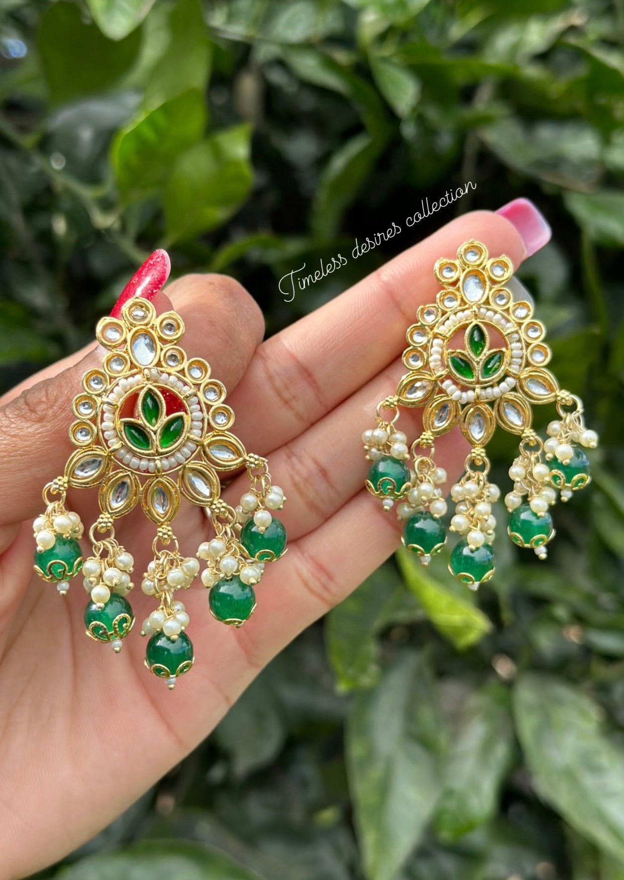 Green pearl loaded earrings in Kundan