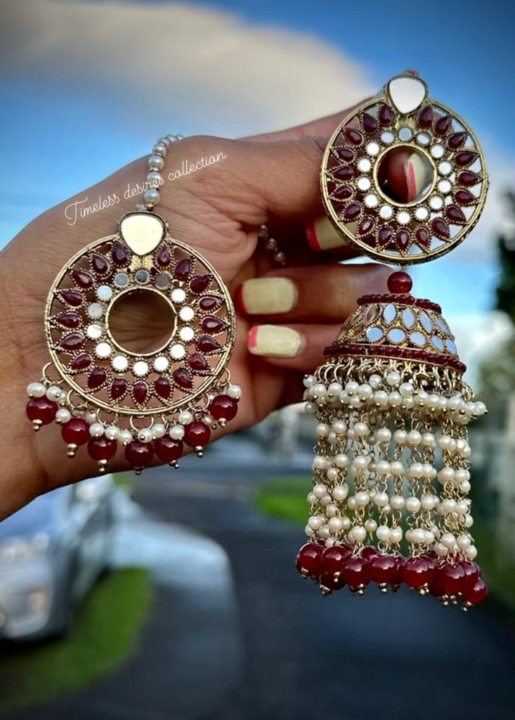 Maroon pearl drop earrings and tikka in mirror