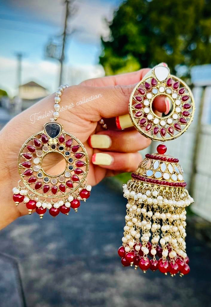 Maroon pearl drop earrings and tikka in mirror