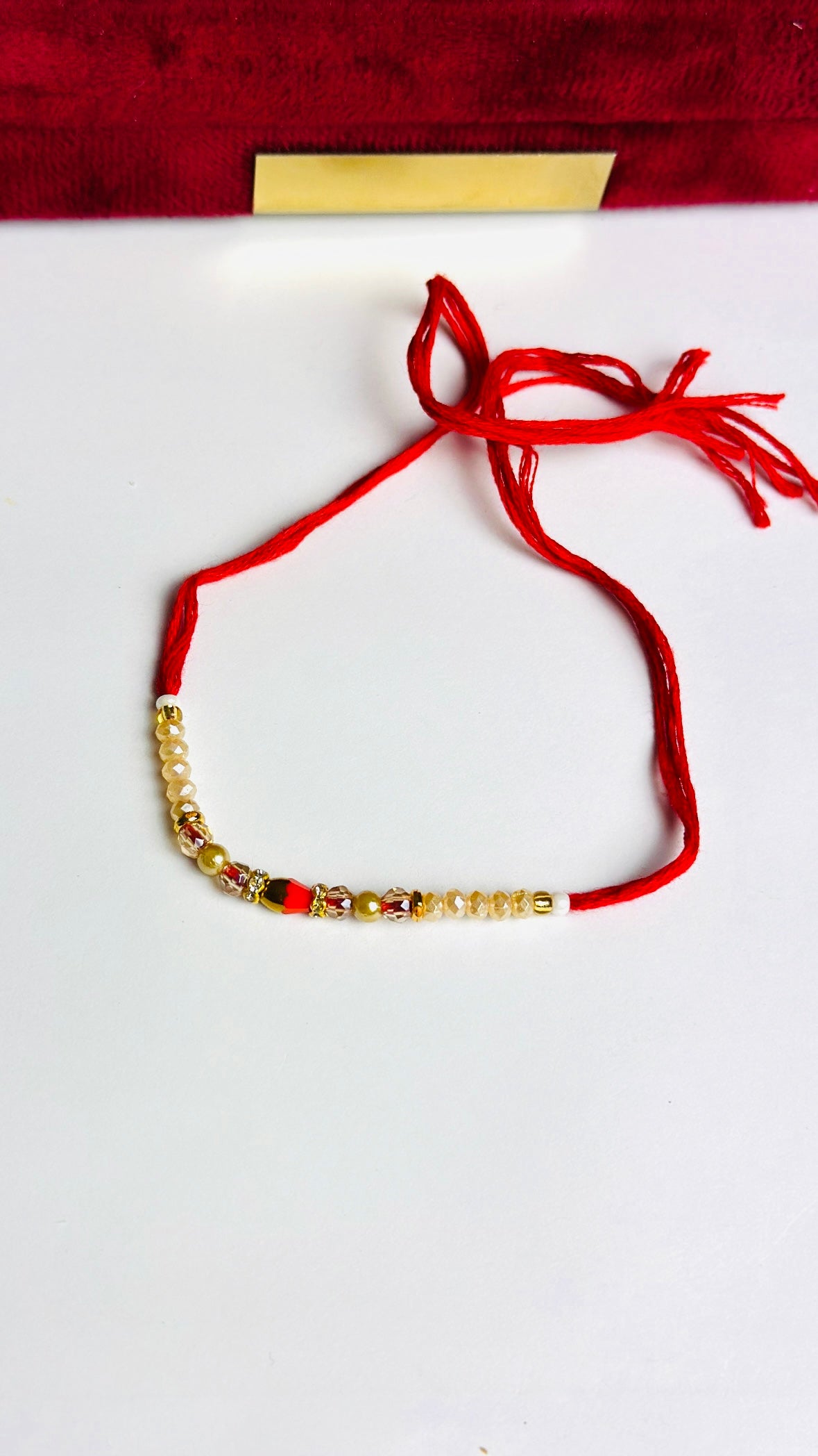 Golden and Red Pearl Loaded Rakhi / Rakhdi Thread in Bundle ( 12 PC set) - Code A52