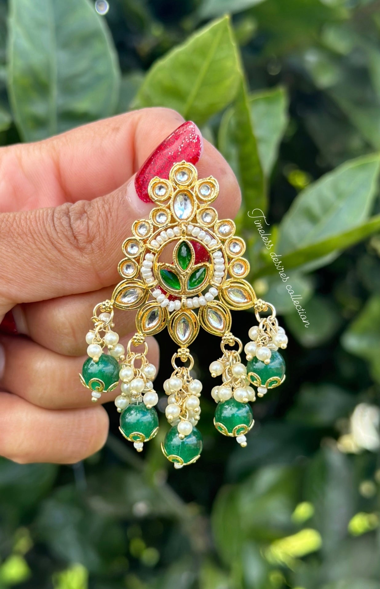 Green pearl loaded earrings in Kundan