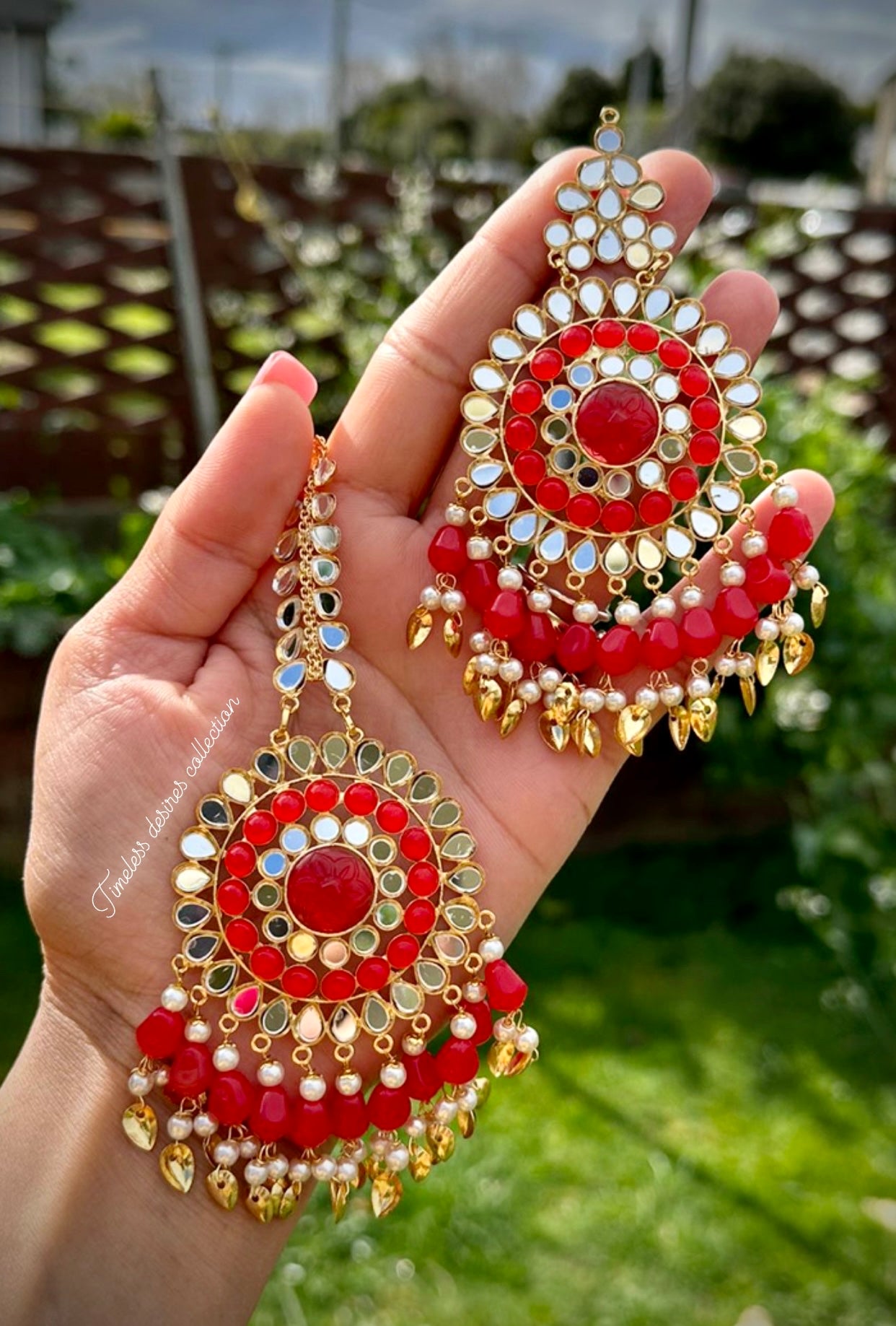 Red earrings and tikka set in mirror with pipal patti