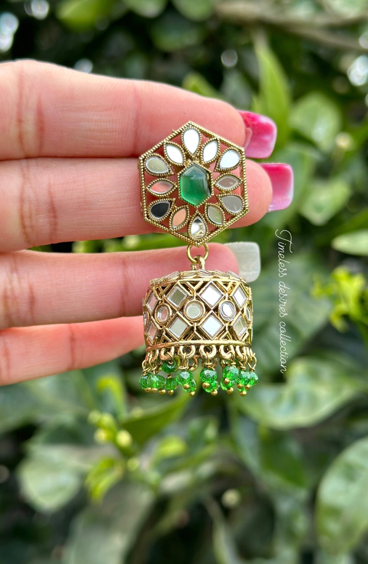 Green Jhumka earrings in mirror