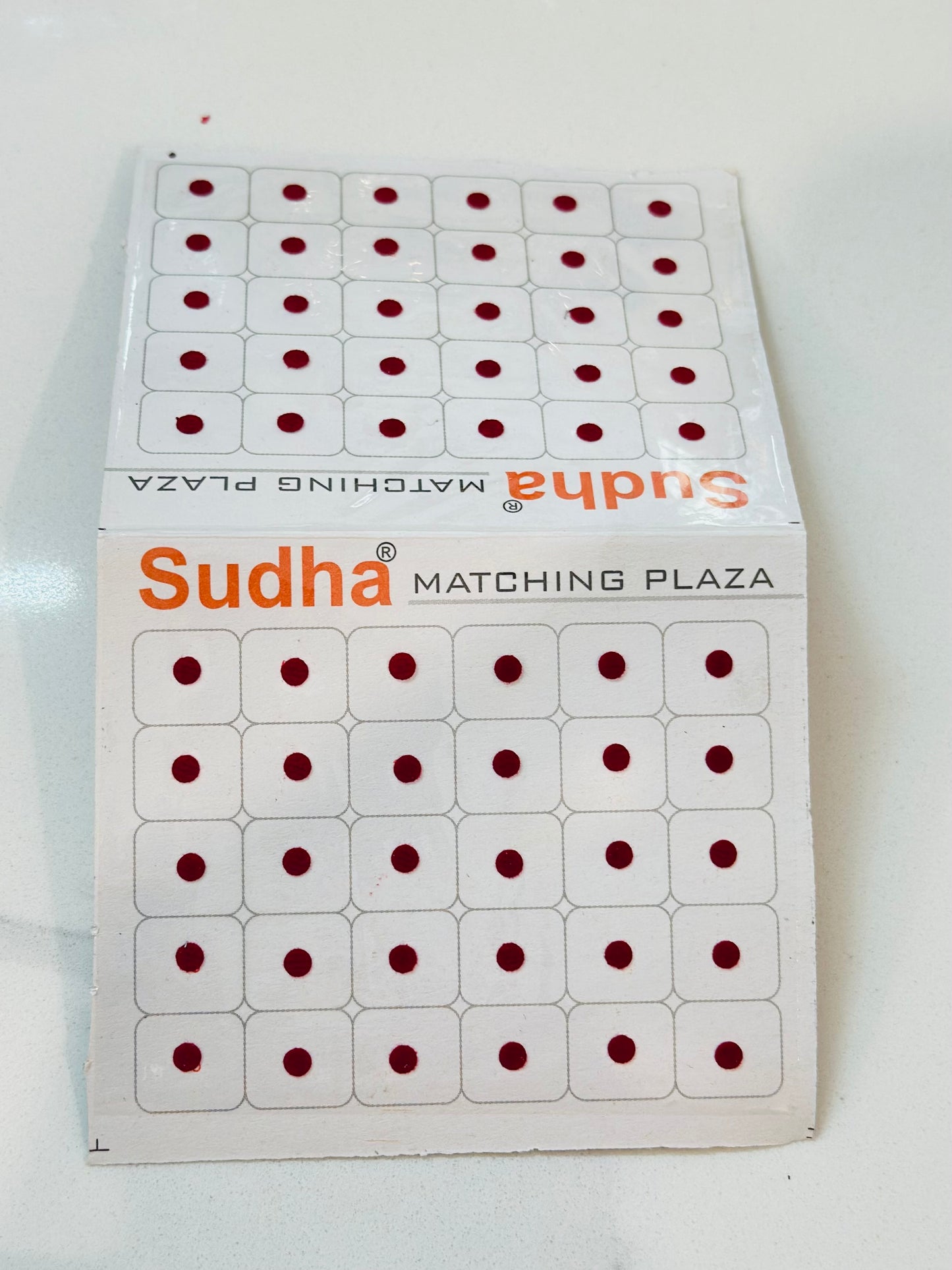 Round shape small bindi card in Maroon colour