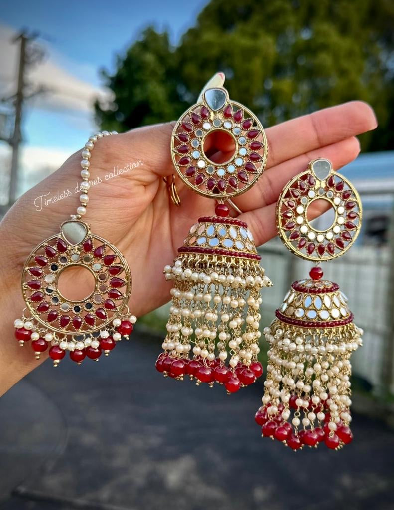 Maroon pearl drop earrings and tikka in mirror