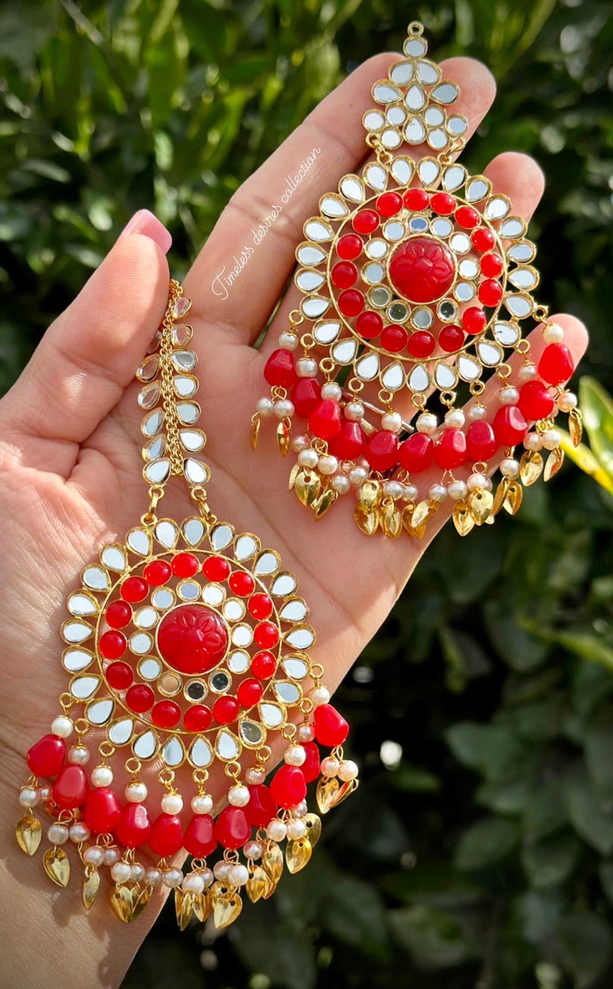 Red earrings and tikka set in mirror with pipal patti