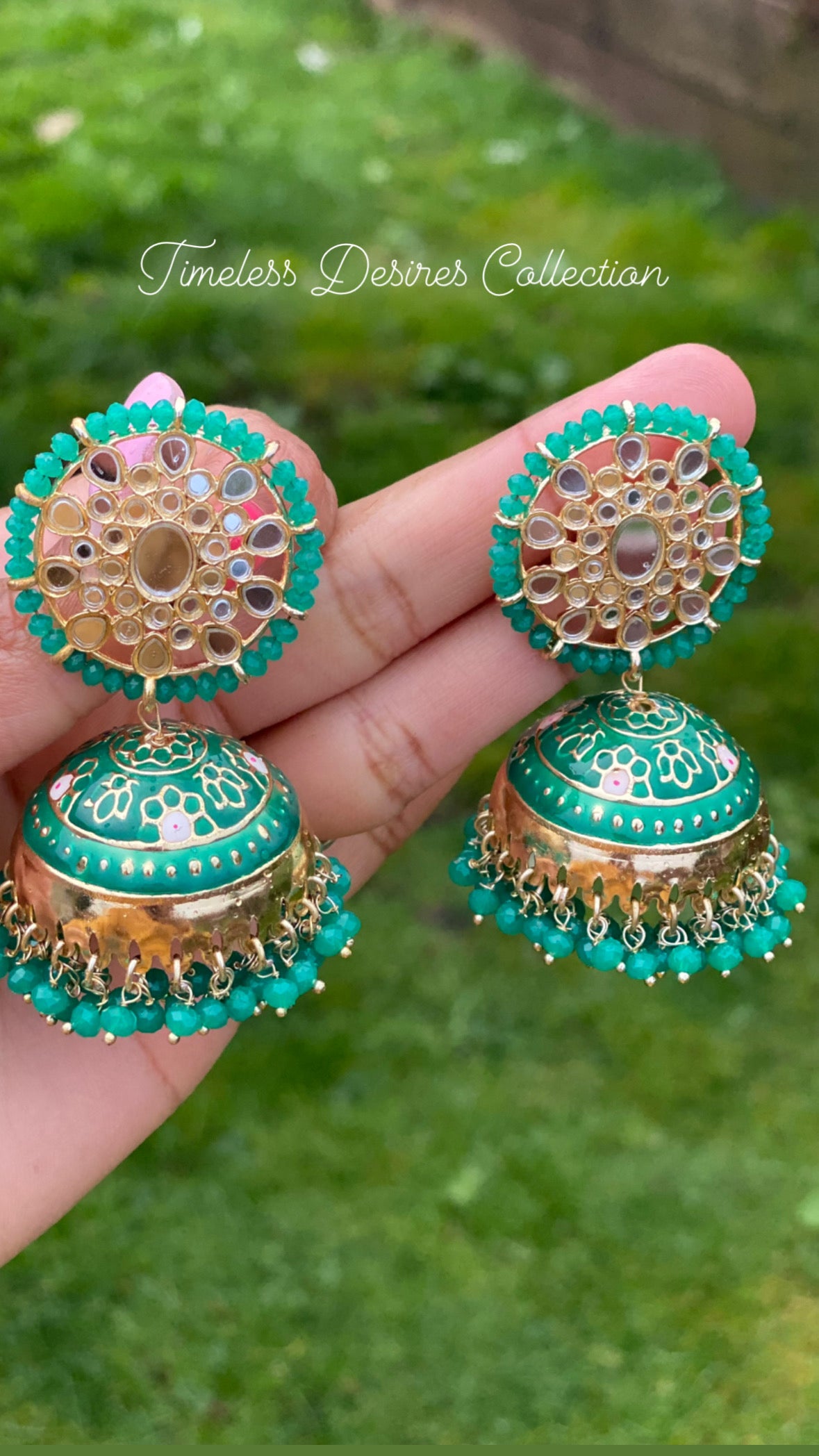 Green jhumka earrings in mirror