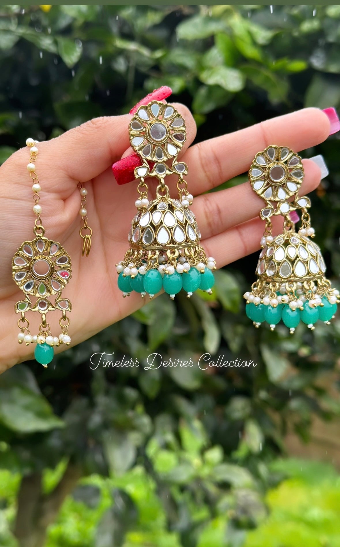 Green Jhumka earrings with tikka in mirror