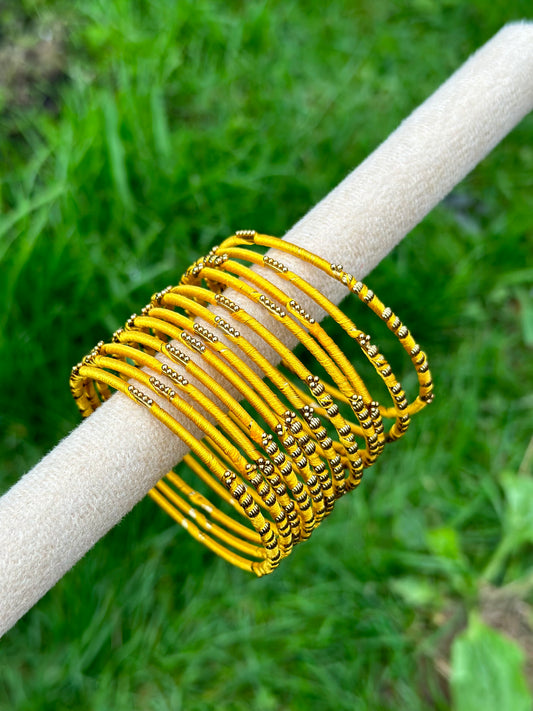 Yellow coloured thread bangles