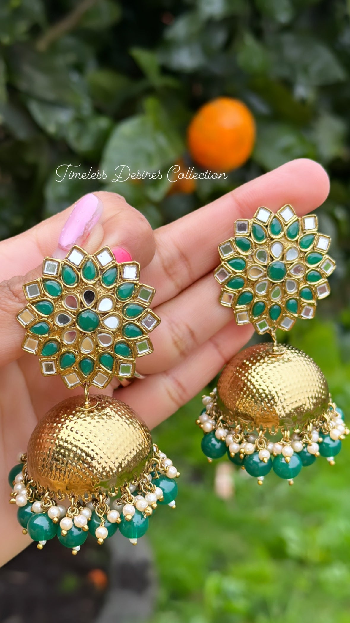 Green Jhumka earrings in mirror