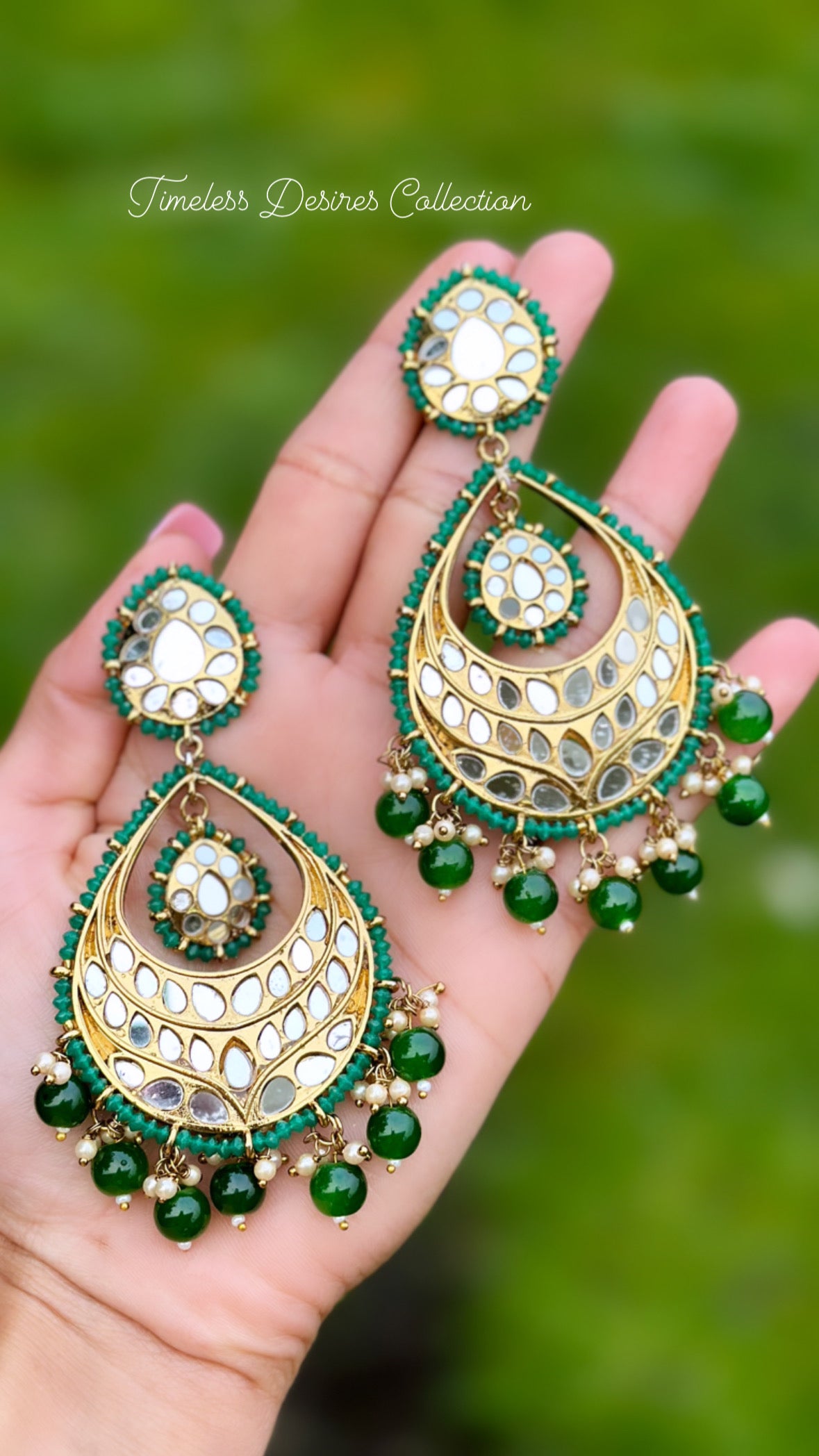 Green earrings in mirror