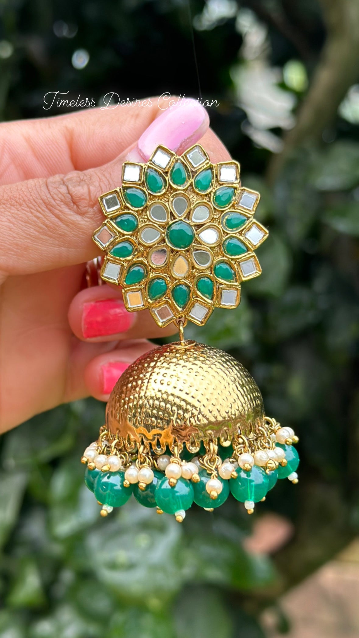 Green Jhumka earrings in mirror