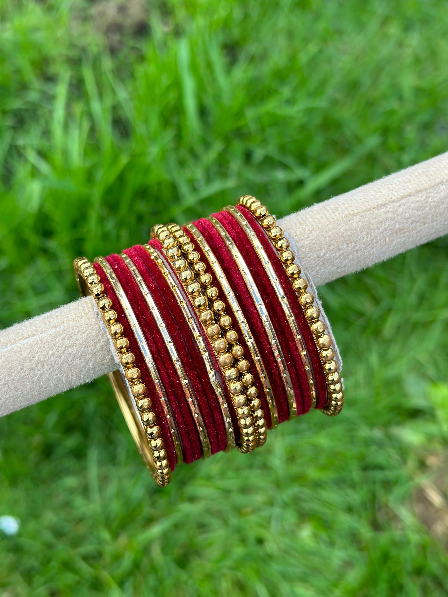 Maroon velvet bangles set with golden beaded kangan’s
