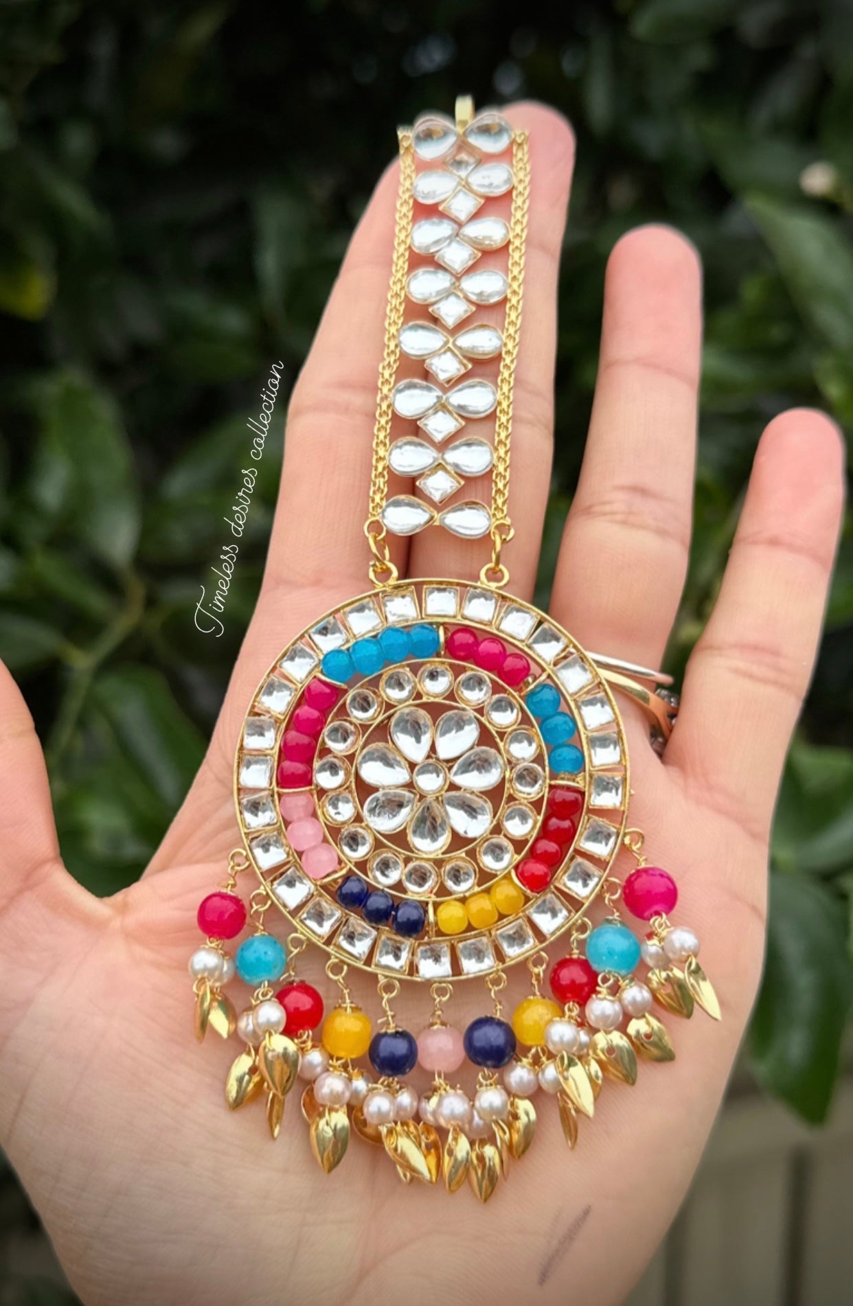 Multi coloured earrings and tikka set with pipal Patti in traditional jewellery
