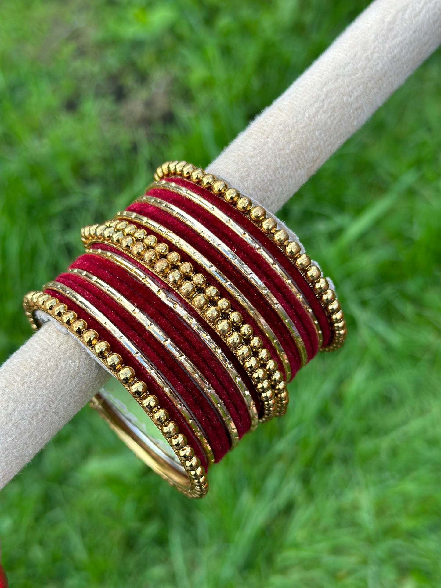 Maroon velvet bangles set with golden beaded kangan’s