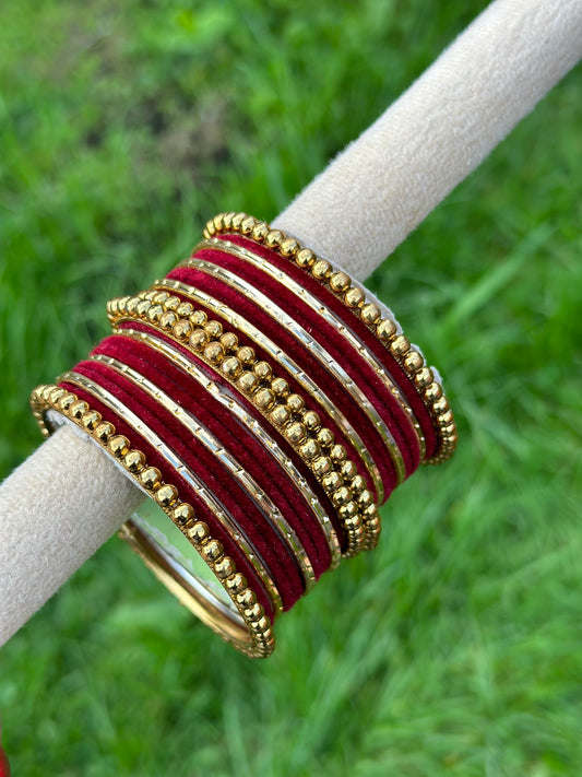 Maroon velvet bangles set with golden beaded kangan’s