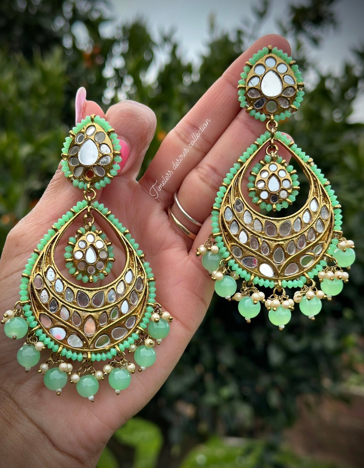 Mint green earrings in mirror