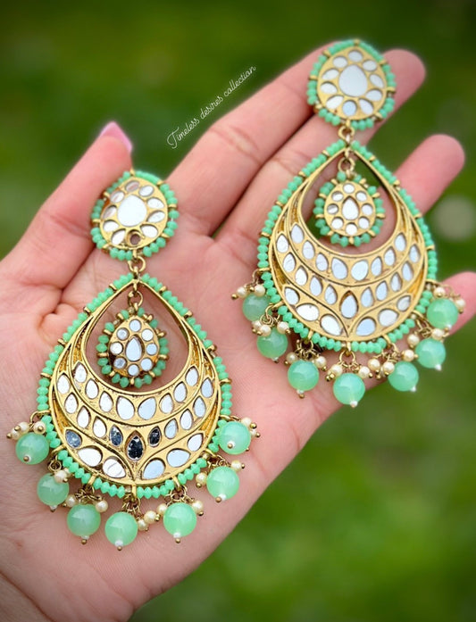 Mint green earrings in mirror
