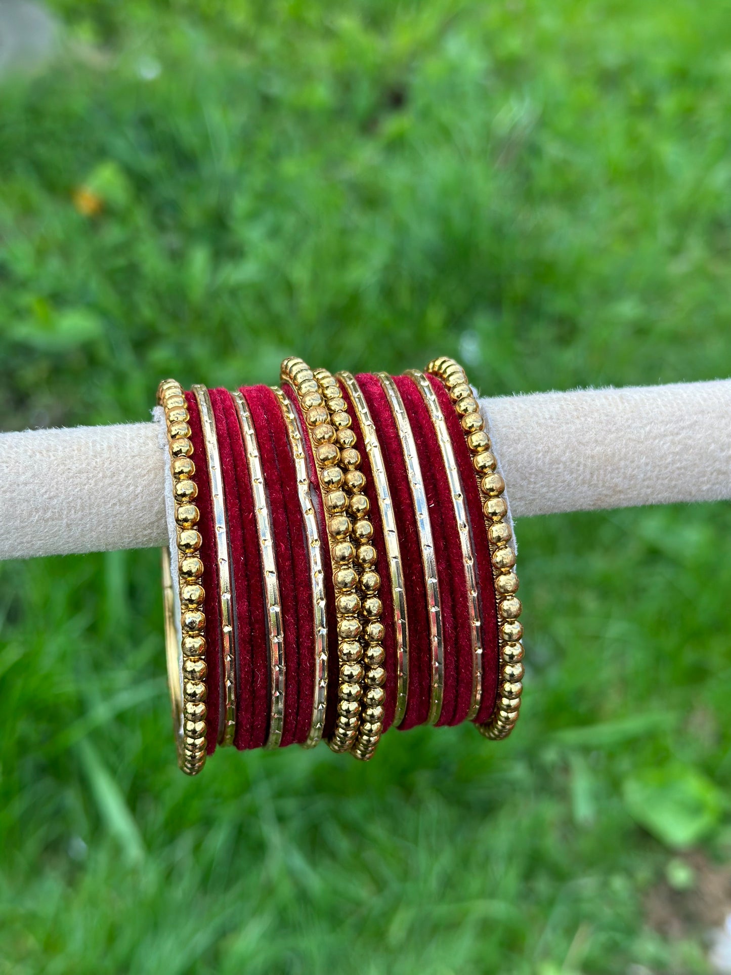 Maroon velvet bangles set with golden beaded kangan’s