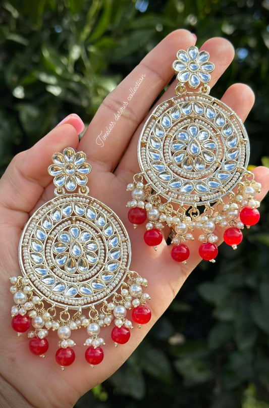 Red pearl loaded earrings in kundan