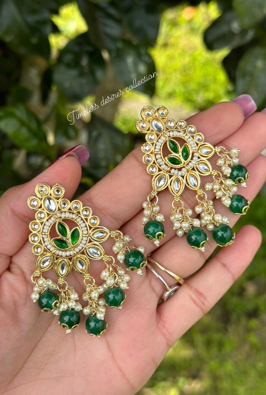 Green pearl loaded earrings in Kundan