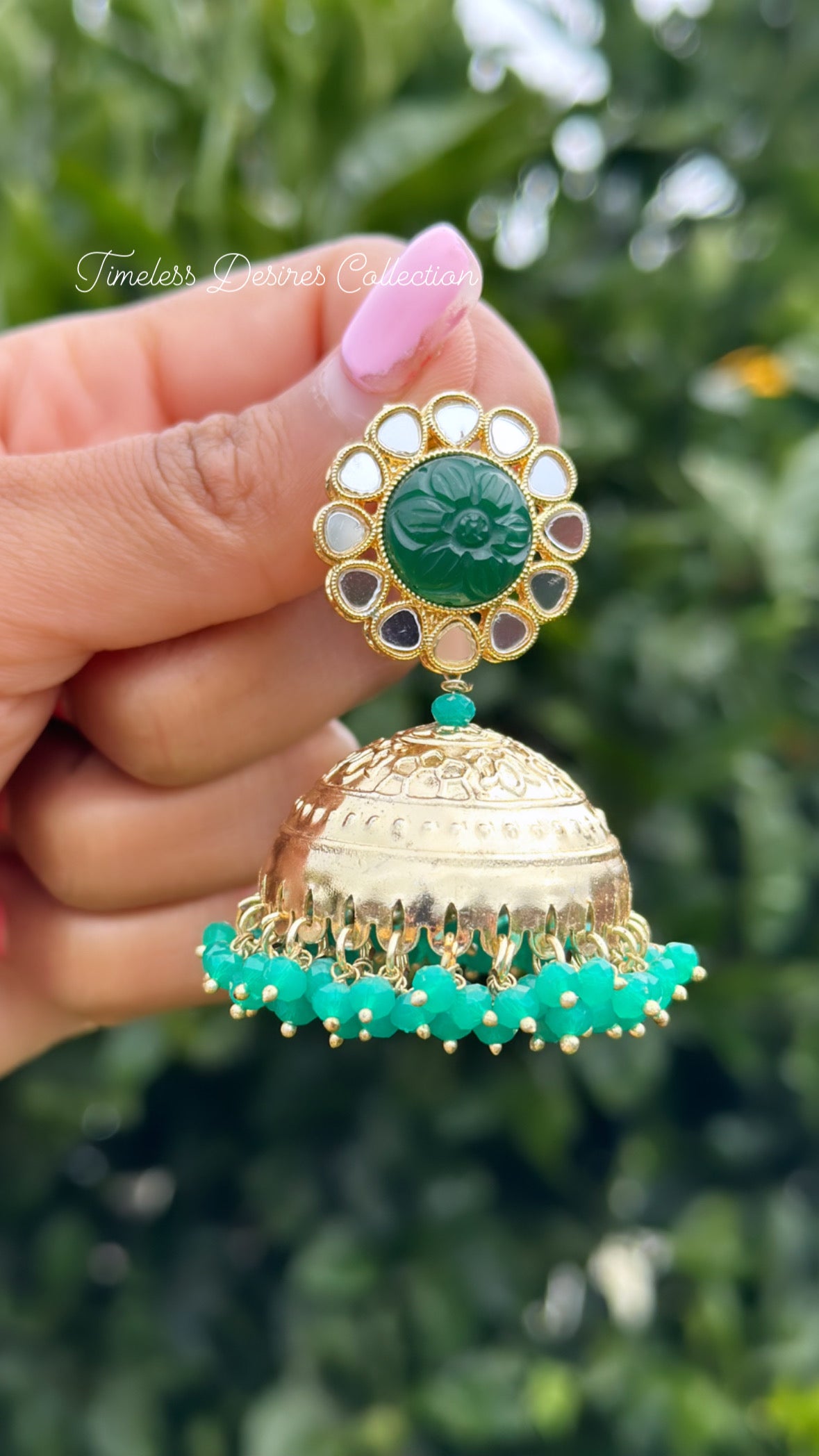 Green Jhumka Earrings in mirror